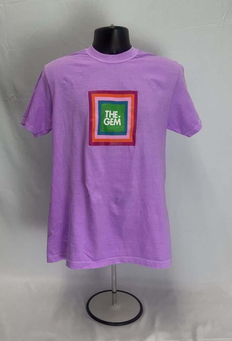 Light purple vintage-dyed t-shirt featuring a multi-color square screen-printed logo reading The Gem.